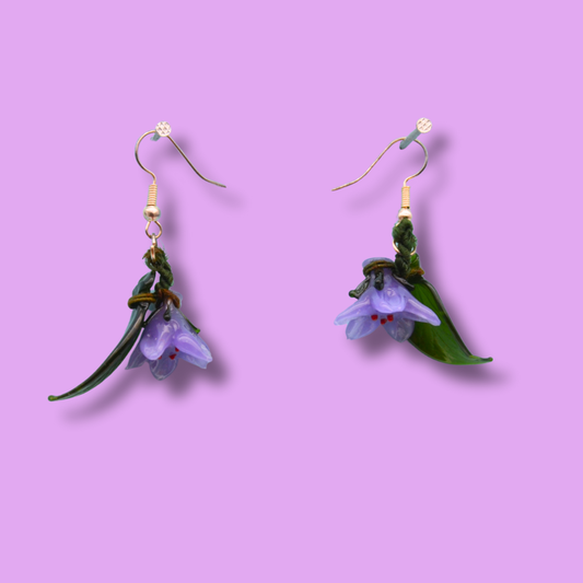 Örhängen lila blommor i glas